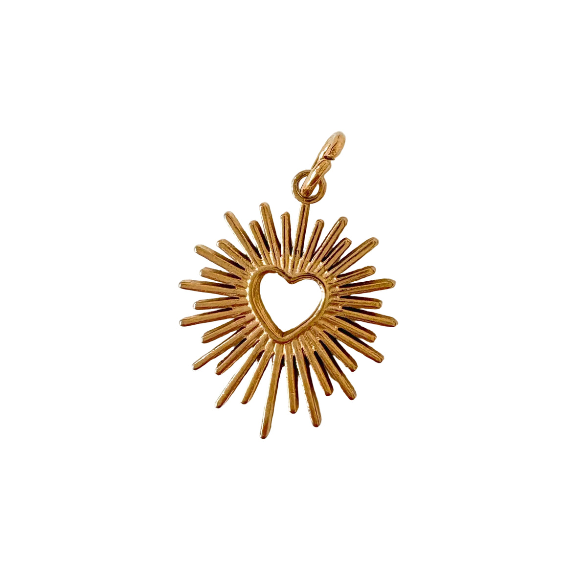 Gold pendant with heart design on a white background