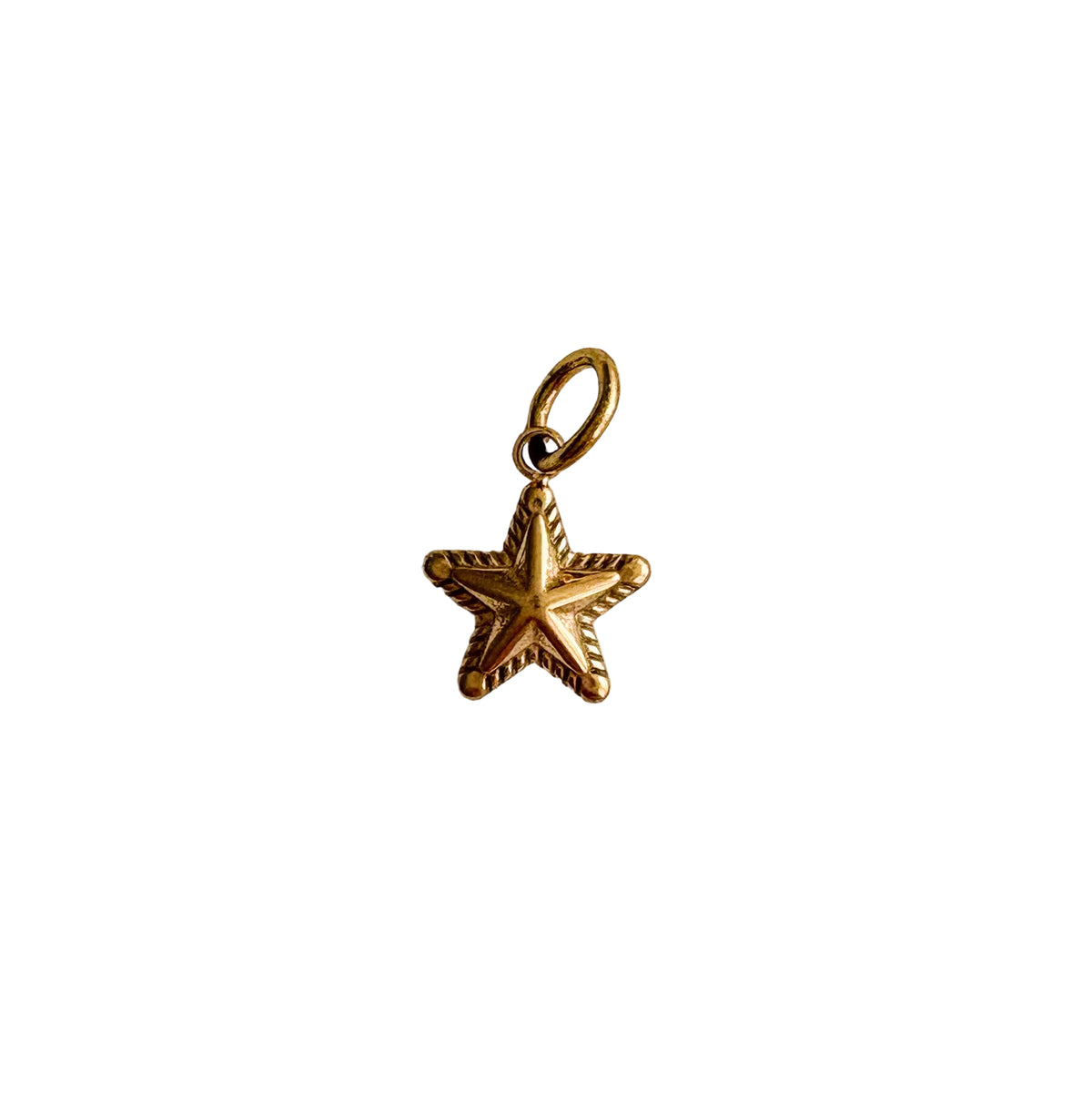 Gold star-shaped pendant on a white textured background