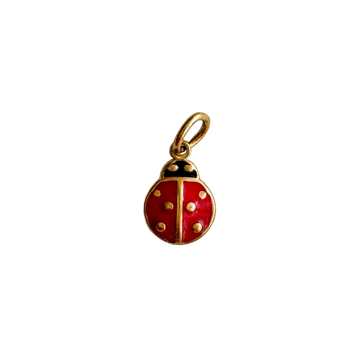 Red ladybug charm with gold accents on a white background