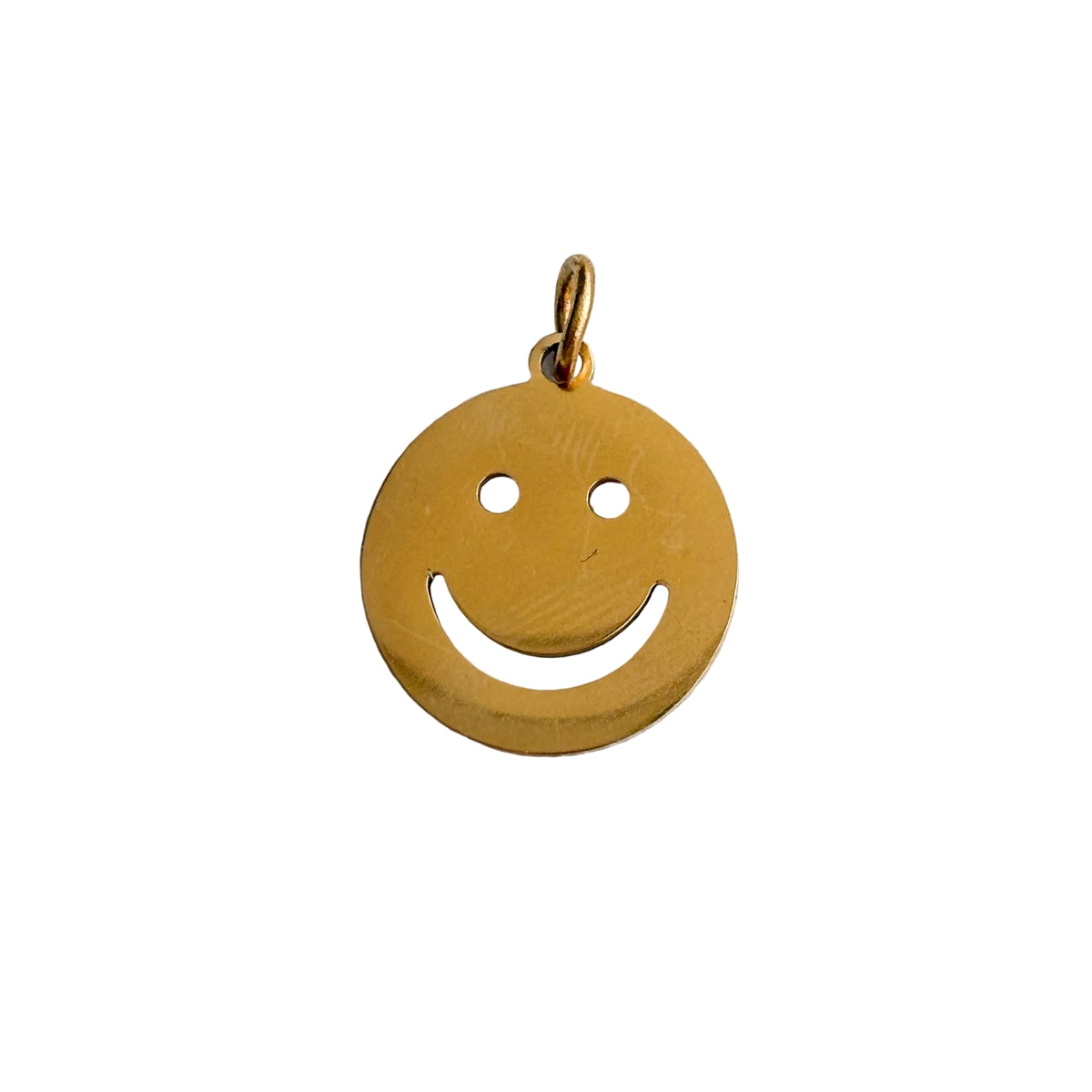 Gold smiley face pendant on a white background