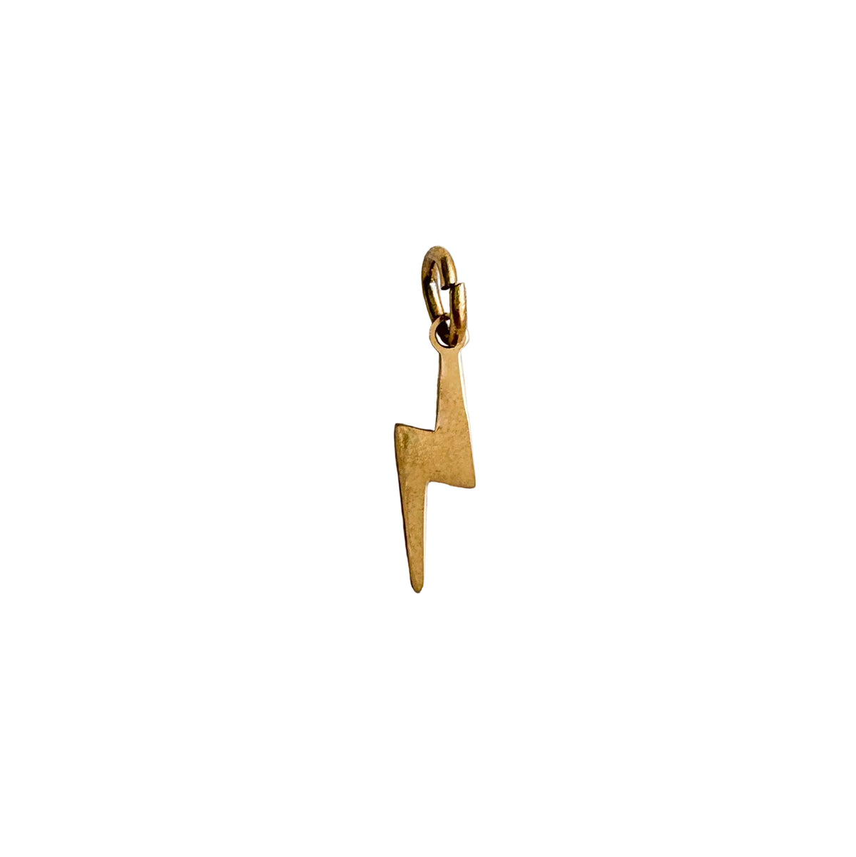Gold lightning bolt pendant on a white textured background