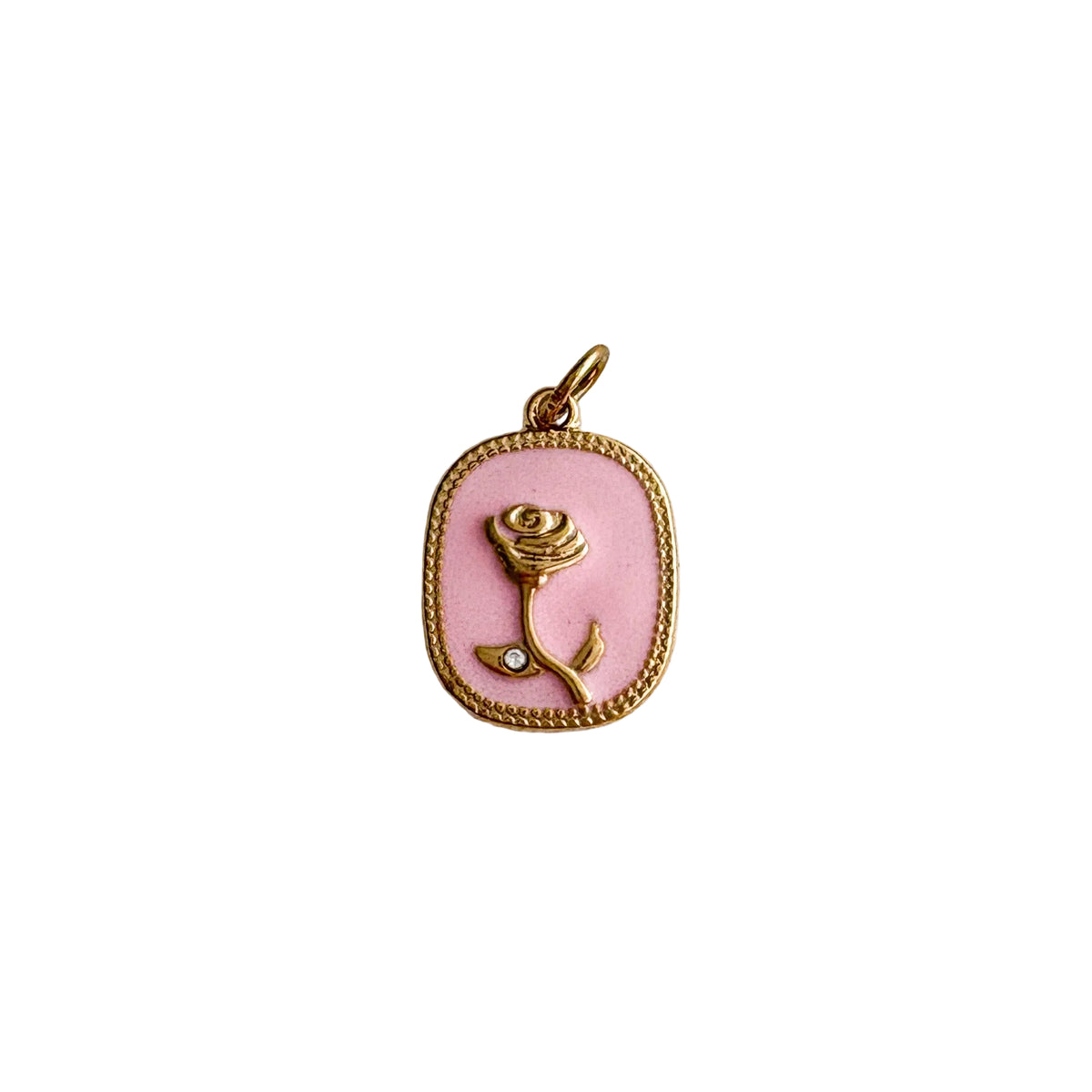 Pink rose pendant with gold frame on a textured white background