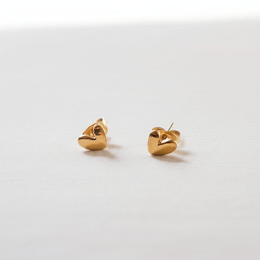 Pair of gold heart-shaped earrings on a white background