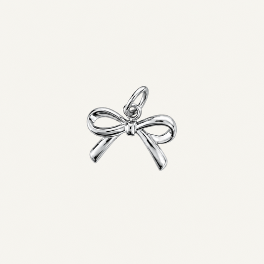 A polished silver charm shaped like a bow, shown on a plain white background.