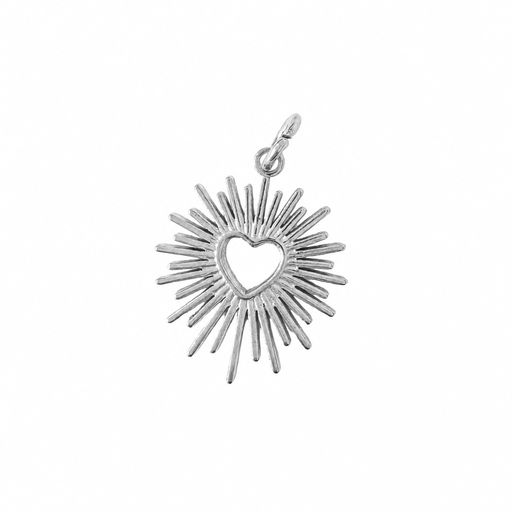 Silver pendant with heart design on a white background