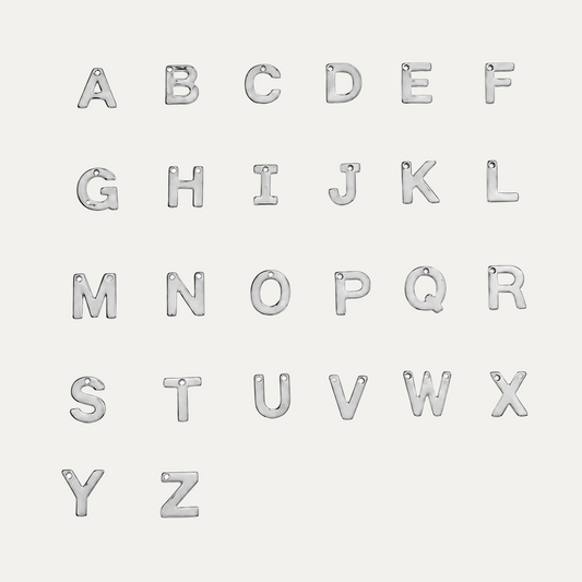 Twenty-six silver metal alphabet letters from A to Z, arranged in five rows on a plain white background. Each letter has a small loop at the top for hanging.