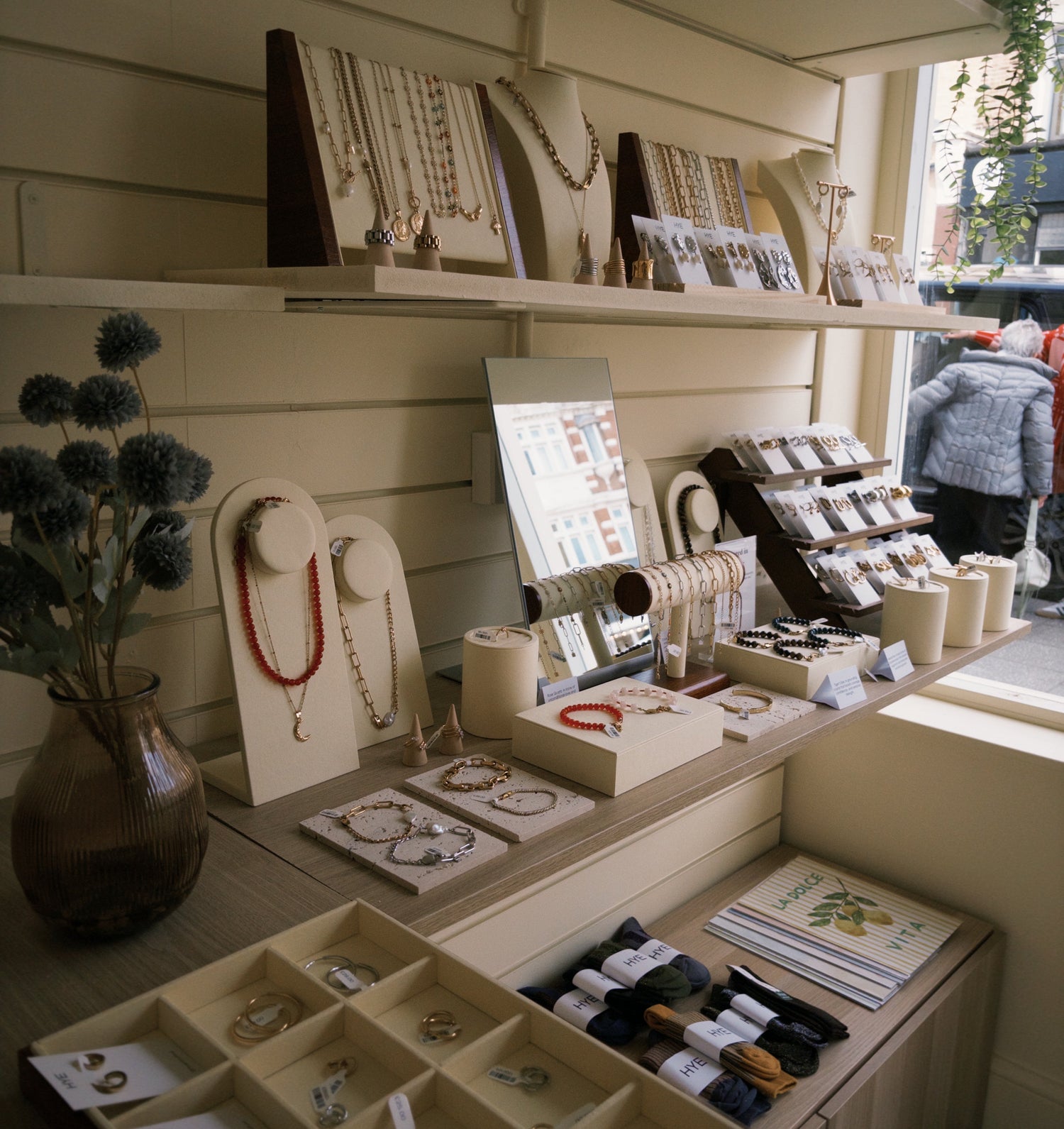 Jewelry store display with various items on shelves and a counter.
